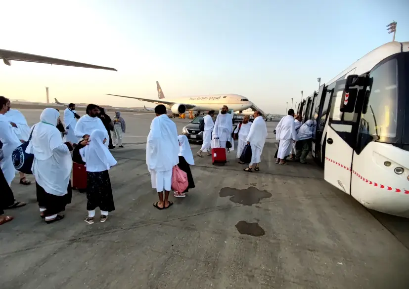 Pilgrims walking to buses at the airport